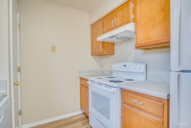 kitchen featuring light hardwood / wood-style floors and white appliances