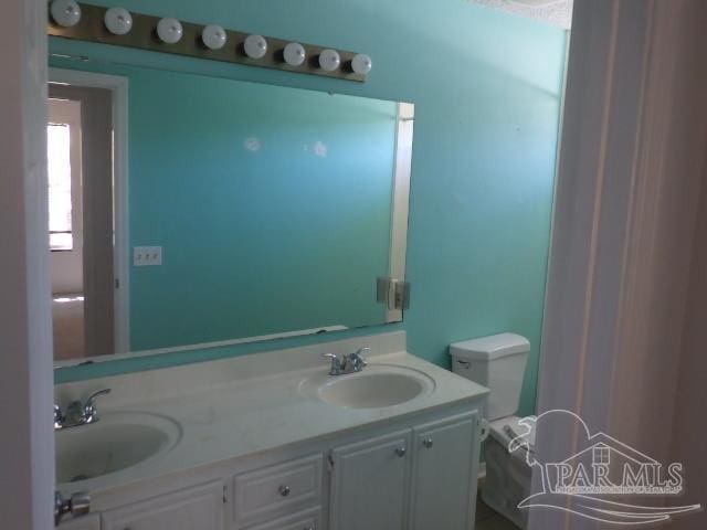 bathroom featuring vanity and toilet