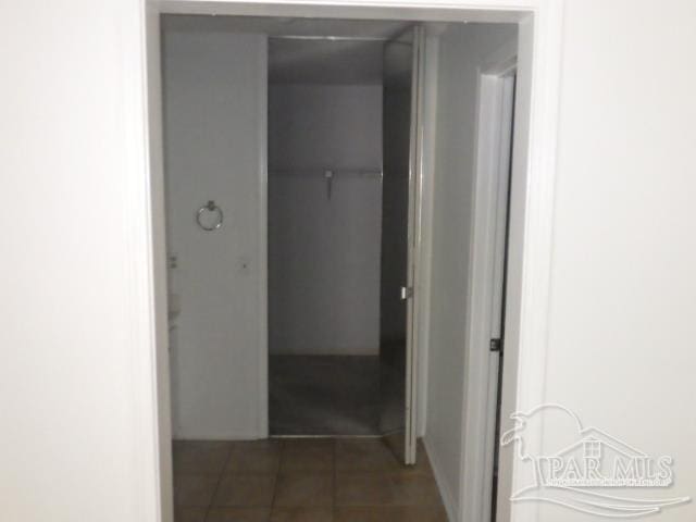 corridor featuring dark tile patterned floors