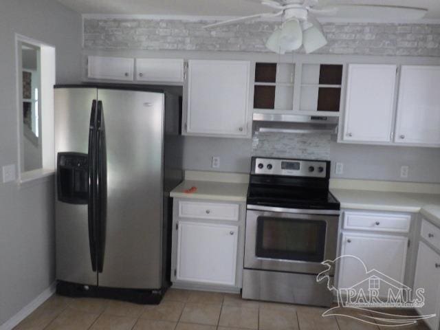 kitchen featuring stainless steel appliances, light tile patterned floors, white cabinets, and ceiling fan