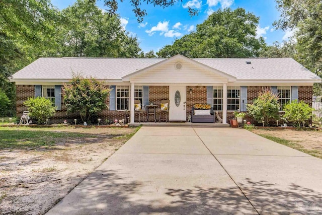 2661 Avenida De Sol, Navarre, FL 32566 - single story home featuring brick siding, covered porch, and a shingled roof