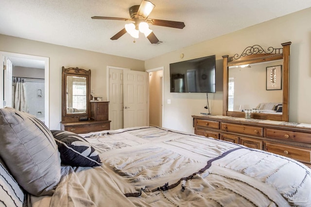 2661 Avenida De Sol, Navarre, FL 32566 - bedroom with ceiling fan, a textured ceiling, and connected bathroom