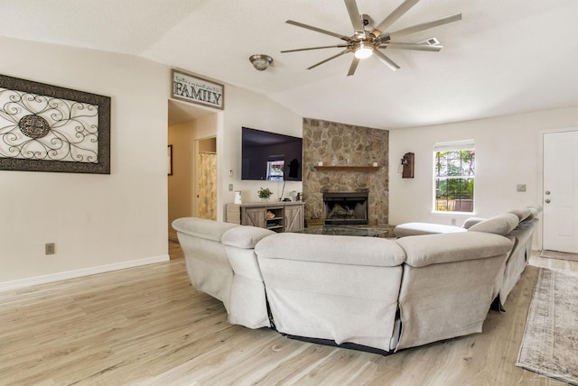 2661 Avenida De Sol, Navarre, FL 32566 - living area featuring lofted ceiling, light wood-type flooring, a ceiling fan, and a stone fireplace