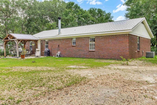 2661 Avenida De Sol, Navarre, FL 32566 - back of house featuring brick siding, a patio, a lawn, and a gazebo