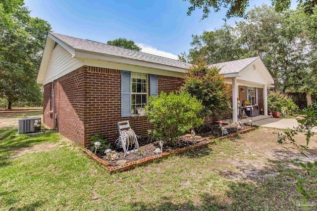 2661 Avenida De Sol, Navarre, FL 32566 - view of side of property featuring brick siding, a lawn, and a patio area