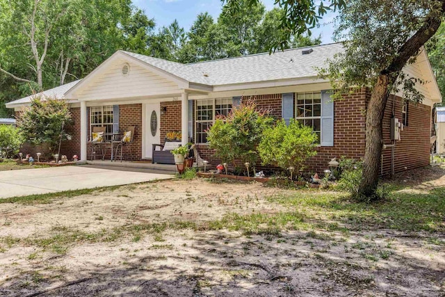2661 Avenida De Sol, Navarre, FL 32566 - ranch-style house with brick siding, roof with shingles, and a porch