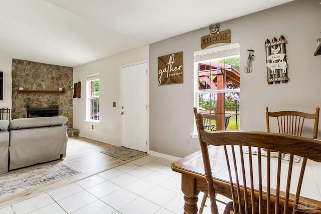 2661 Avenida De Sol, Navarre, FL 32566 - dining area with plenty of natural light, a fireplace, and light tile patterned floors