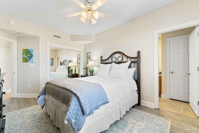 bedroom with ceiling fan, visible vents, baseboards, a closet, and light wood finished floors