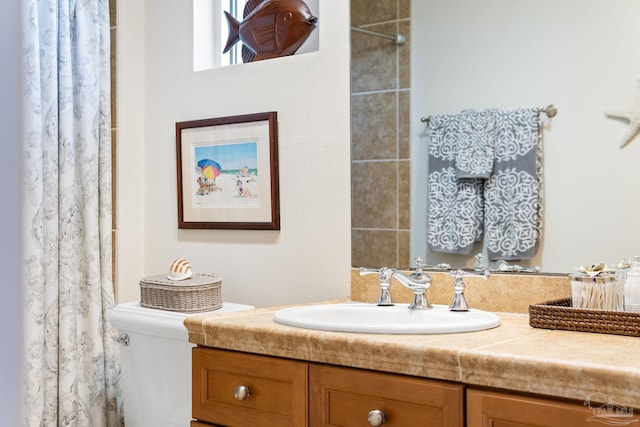 bathroom with toilet and vanity