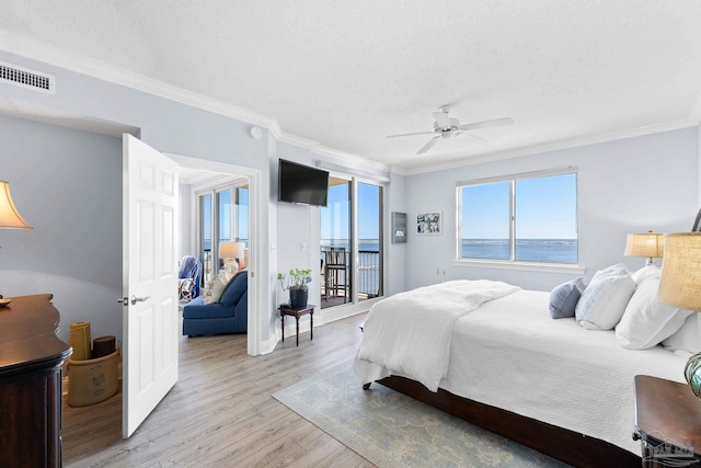 bedroom with visible vents, access to exterior, a textured ceiling, crown molding, and light wood-type flooring