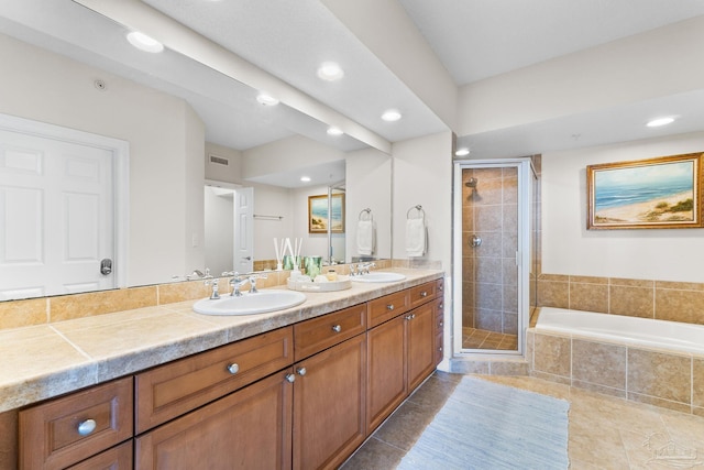 bathroom with double vanity, recessed lighting, a sink, and a shower stall