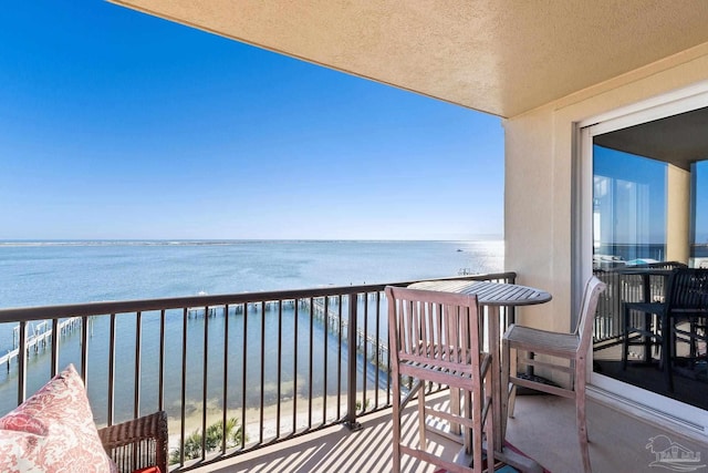 balcony with a beach view and a water view