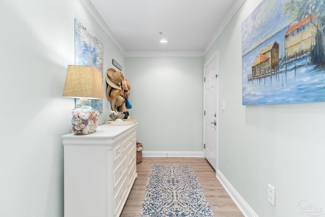 entryway featuring baseboards, ornamental molding, and wood finished floors