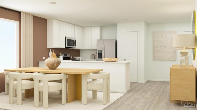 4766 Runway Dr Lot 16G, Pace, FL 32571 - kitchen featuring white cabinets, appliances with stainless steel finishes, light wood finished floors, light countertops, and a peninsula