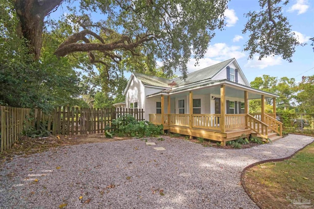 view of side of property featuring covered porch