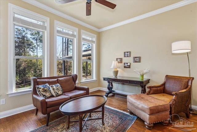 living area featuring ornamental molding, plenty of natural light, and wood finished floors