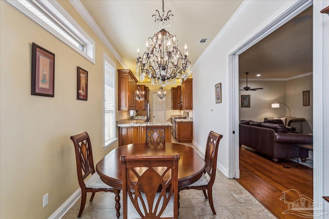 dining space featuring visible vents, ornamental molding, baseboards, and ceiling fan with notable chandelier