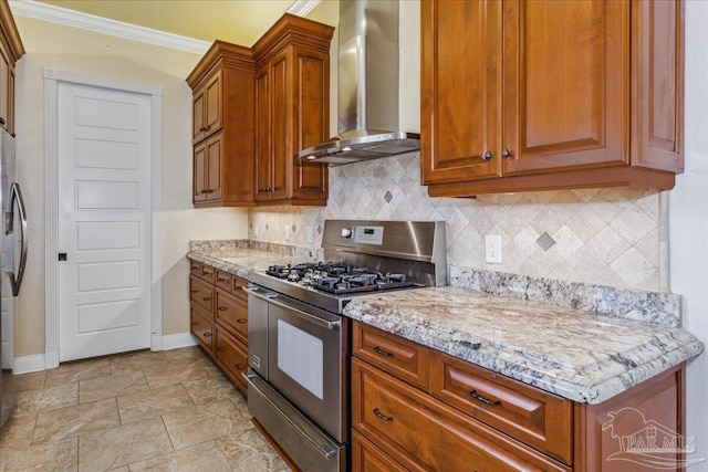 kitchen featuring brown cabinets, stainless steel appliances, backsplash, light stone countertops, and wall chimney exhaust hood