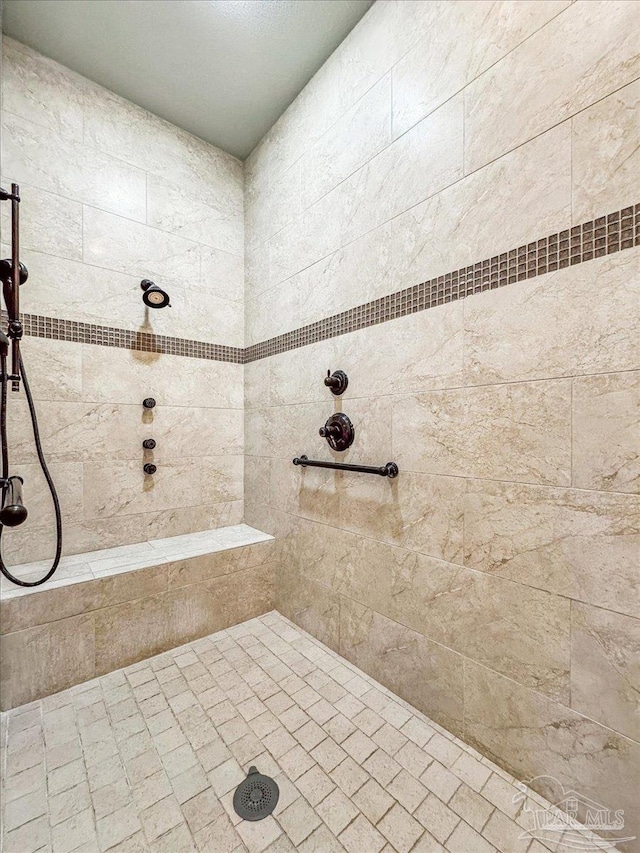 bathroom with tiled shower