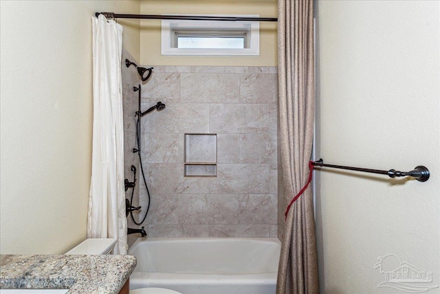 bathroom featuring vanity, shower / bath combo with shower curtain, and toilet