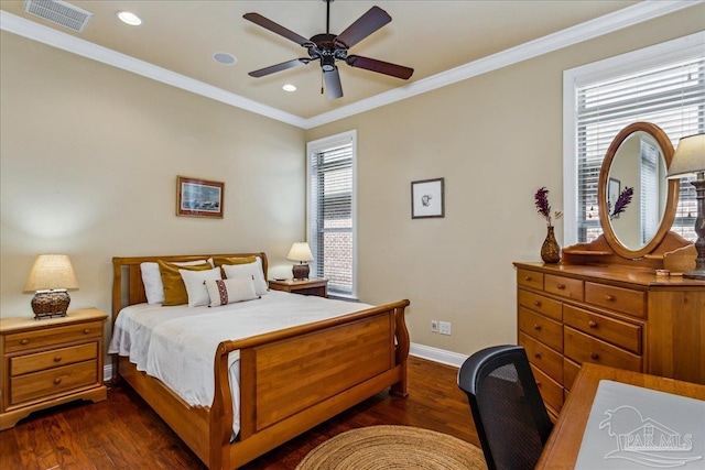 bedroom with baseboards, visible vents, a ceiling fan, dark wood finished floors, and crown molding