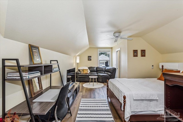 bedroom with lofted ceiling, ceiling fan, and wood finished floors