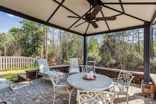 sunroom featuring ceiling fan and a wealth of natural light