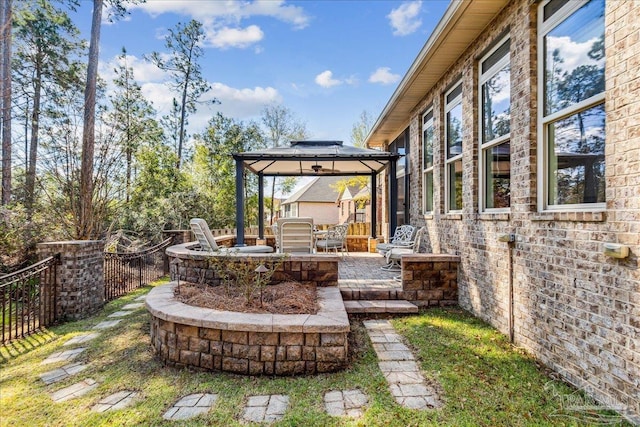 view of yard featuring a patio area, fence, and a gazebo