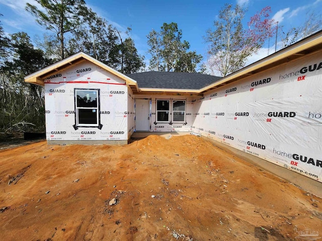 property under construction with roof with shingles