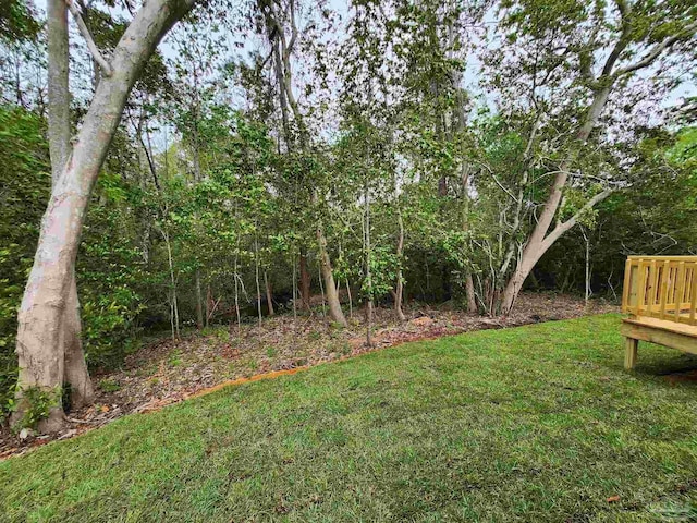 1581 Kyle Dr, Pensacola, FL 32505 - view of green lawn with a wooden deck