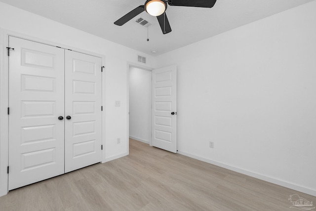 1581 Kyle Dr, Pensacola, FL 32505 - unfurnished bedroom with light wood-style floors, baseboards, a closet, and a ceiling fan
