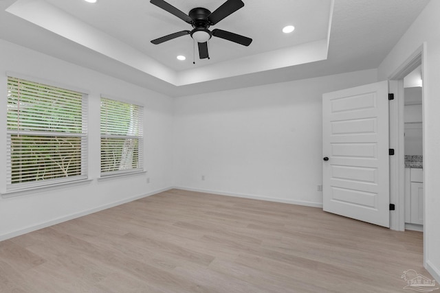 1581 Kyle Dr, Pensacola, FL 32505 - unfurnished room with a raised ceiling, light wood-style flooring, recessed lighting, a ceiling fan, and baseboards
