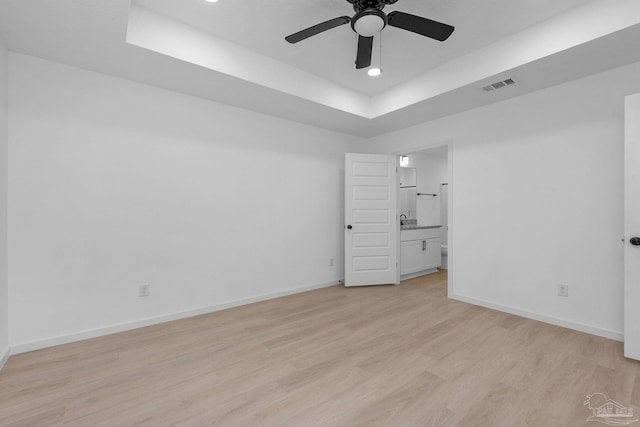 1581 Kyle Dr, Pensacola, FL 32505 - spare room with a tray ceiling, light wood finished floors, ceiling fan, baseboards, and recessed lighting
