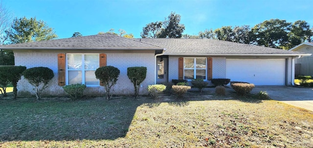 ranch-style home featuring a garage and a front lawn