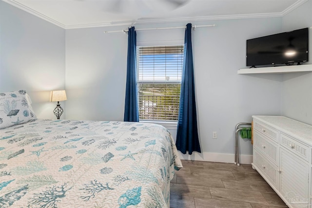 bedroom featuring light hardwood / wood-style flooring, ceiling fan, and ornamental molding