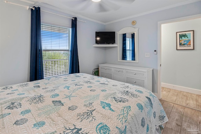 bedroom featuring ceiling fan, ornamental molding, and light wood-type flooring