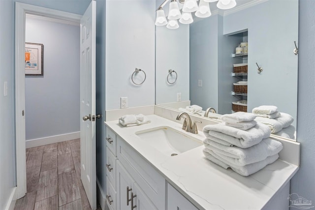 bathroom featuring crown molding, vanity, and hardwood / wood-style flooring