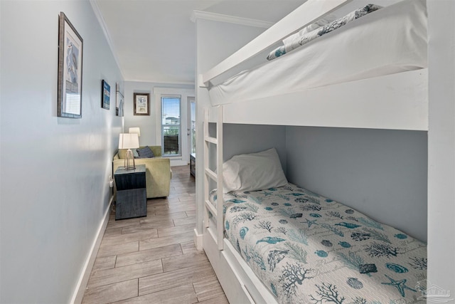 bedroom with ornamental molding and light hardwood / wood-style flooring