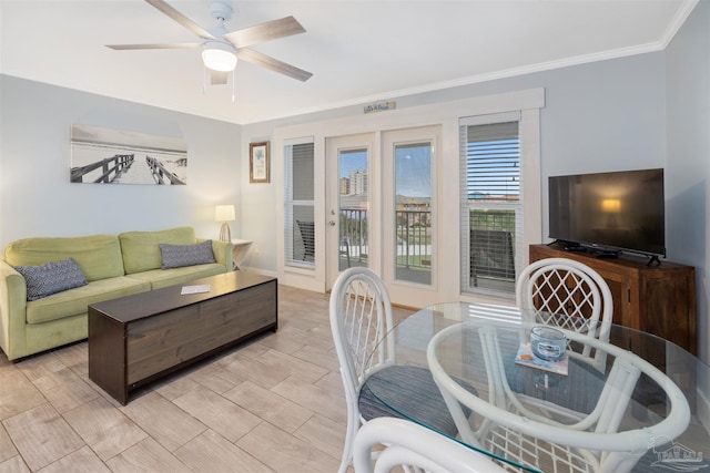 living room featuring light hardwood / wood-style flooring, ceiling fan, and ornamental molding