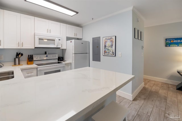 kitchen featuring ornamental molding, light wood-type flooring, white appliances, and white cabinetry