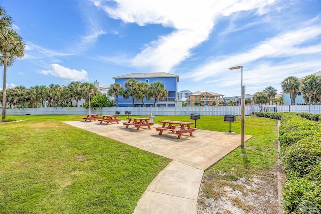 view of community featuring a yard and a patio