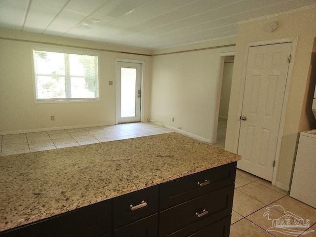 729 Lownde Ave, Pensacola, FL 32507 - kitchen with dark cabinets, light tile patterned floors, and light stone countertops