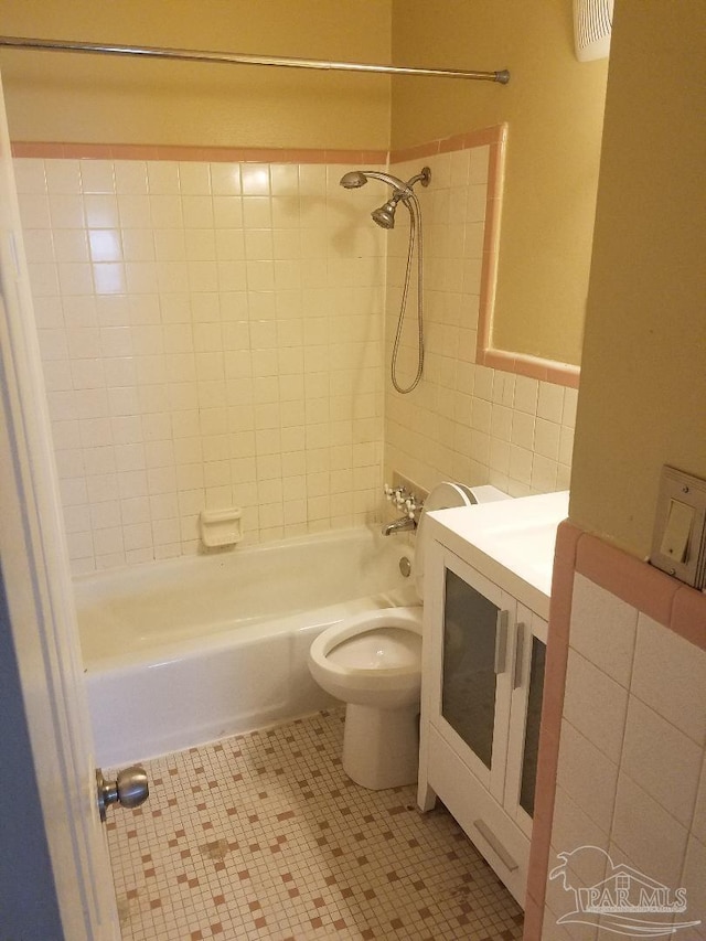 729 Lownde Ave, Pensacola, FL 32507 - full bathroom featuring  shower combination, toilet, tile walls, vanity, and tile patterned floors