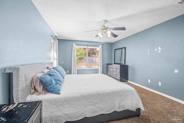 bedroom featuring a textured ceiling, carpet floors, and ceiling fan