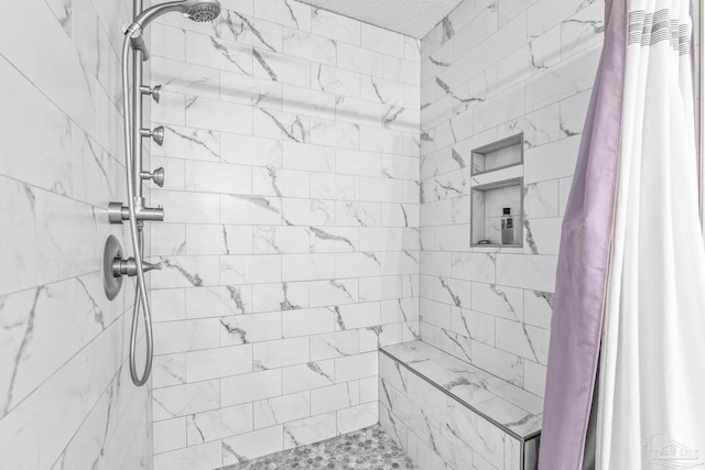 bathroom with a textured ceiling and walk in shower