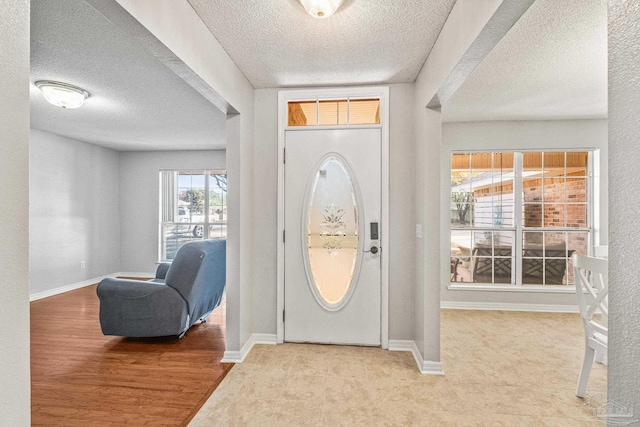 entryway featuring hardwood / wood-style floors and a textured ceiling