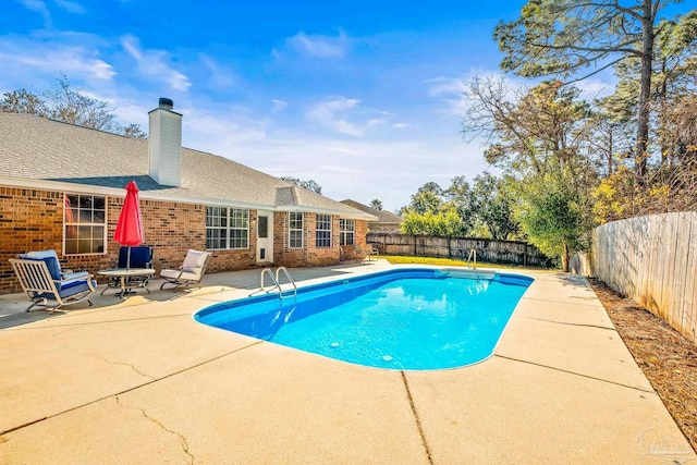 view of swimming pool with a patio area