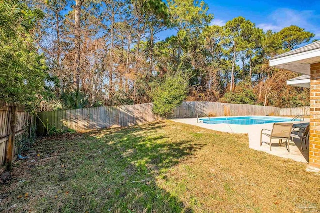 view of yard with a fenced in pool and a patio