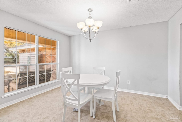 dining room with a textured ceiling and a notable chandelier