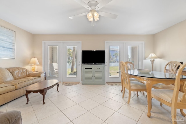 tiled living room with ceiling fan and french doors